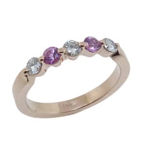 14 karat rose gold band claw set three round brilliant cut diamonds and two pink sapphires.