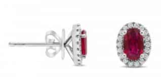 14K white gold stud earrings set with 2 = 1.28cttw rubies accented with 36 = 0.16cttw round brilliant cut diamonds.