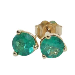Lady's yellow gold three prong earrings set with two round emeralds totaling 0.77 carats.