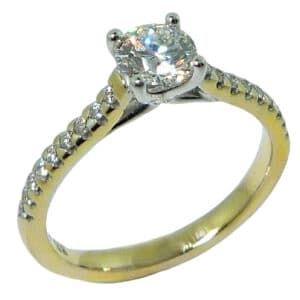 14K yellow and white gold solitaire engagement ring set with a 0.535ct I, VS2 round brilliant cut diamond by Hearts On Fire accented with 0.157cttw G/H, VS2-SI1 round brilliant cut diamonds by Hearts On Fire. 