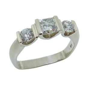 Lady's 14K white gold ring, bar-set with a 0.502 carat, J, SI2 CanadaMark princess cut diamond and on the sides are two, I-J, SI2, ideal round brilliant cut diamonds, totaling 0.373 carats.