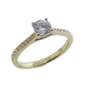 14K yellow and white gold solitaire engagement ring set with a 0.50ct cubic zirconia in the center and accented with 18 = 0.17cttw G/H, VS-SI round brilliant cut diamonds.