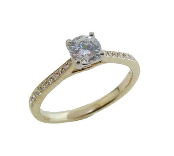 14K yellow and white gold solitaire engagement ring set with a 0.50ct cubic zirconia in the center and accented with 18 = 0.17cttw G/H, VS-SI round brilliant cut diamonds.