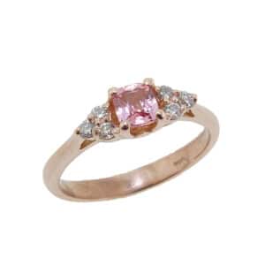 14K rose gold ring set with a 0.407ct Padparadscha sapphire and accented with 6 = 0.13cttw H, SI1-2 round brilliant cut diamonds.
