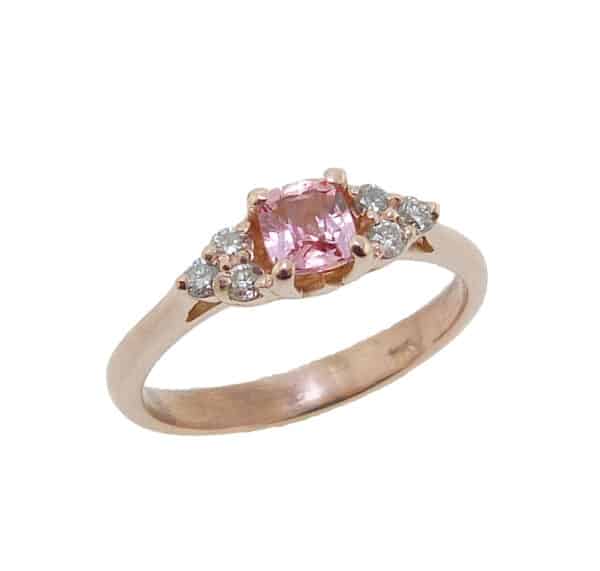 14K rose gold ring set with a 0.407ct Padparadscha sapphire and accented with 6 = 0.13cttw H, SI1-2 round brilliant cut diamonds.