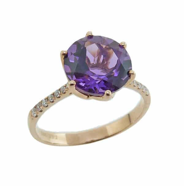 14K yellow ring set with 9mm amethyst and 0.11cttw, G/H, SI, round brilliant cut diamonds.