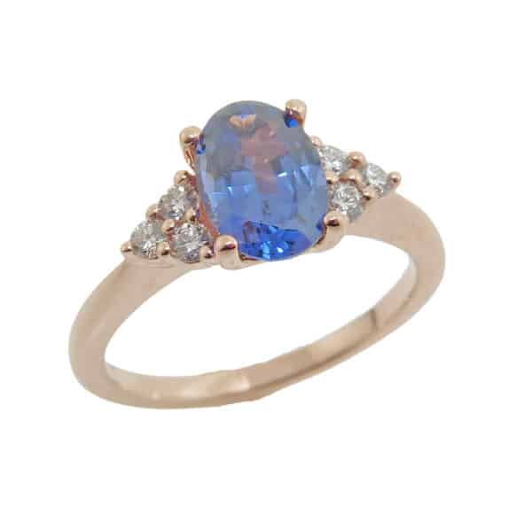 14K rose gold ring set with a 1.20ct oval blue Spinel and accented with 6 = 0.17cttw E/F, VS2-SI round brilliant cut diamonds.