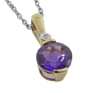 14K white gold pendant set with a 7.5-8mm round amethyst and accented with a 0.01ct round brilliant cut diamond.