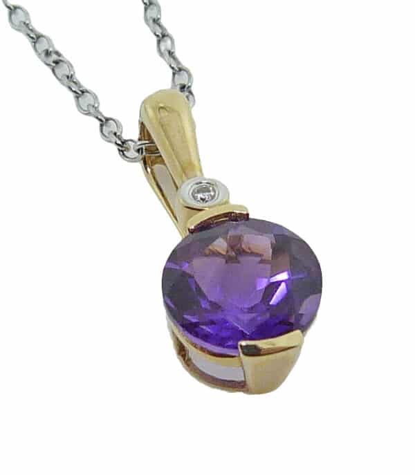 14K white gold pendant set with a 7.5-8mm round amethyst and accented with a 0.01ct round brilliant cut diamond.