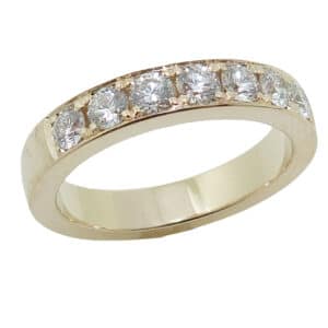 Lady's 14K yellow gold diamond band bead-set with seven, G-H, VS-SI, very good-excellent cut, round brilliant cut diamonds, totaling 0.70 carats.