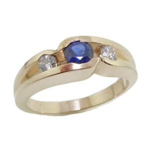 Lady's 14K yellow gold ring set with one 0.37 carat round blue sapphire and two ideal round brilliant cut diamonds totaling 0.183 carats, H-I SI2