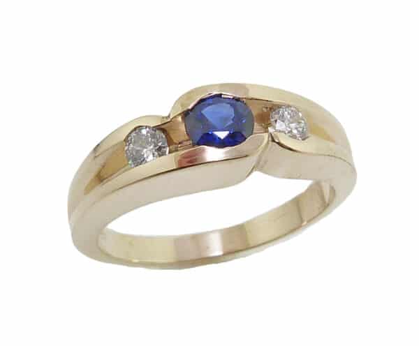 Lady's 14K yellow gold ring set with one 0.37 carat round blue sapphire and two ideal round brilliant cut diamonds totaling 0.183 carats, H-I SI2
