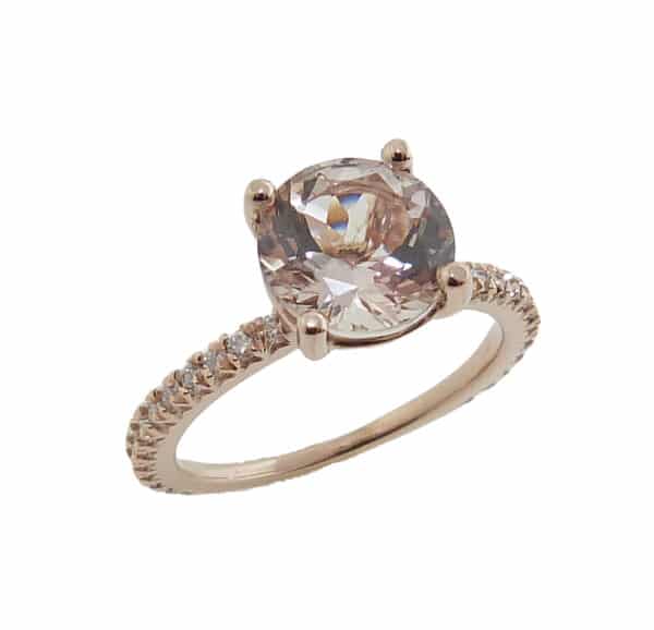 14K rose gold ring set with a round 1.84ct Morganite and accented on the band with 0.26cttw H, SI1-2 round brilliant cut diamonds.