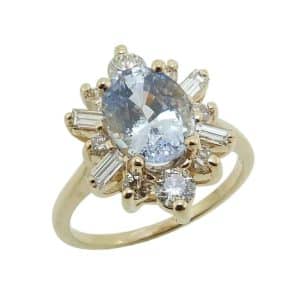 14K Yellow gold lady's coloured gemstone stylized halo lady's ring set with a 2.667 carat light Ceylon sapphire and accented with 12 round brilliant cut diamonds, 0.78 total carat weight, G/H, SI.