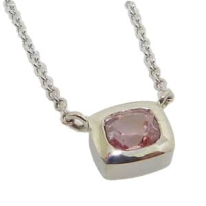 14k white gold bezel set 0.506ct pink sapphire with a 14k white gold 16" adjustable light cable chain.