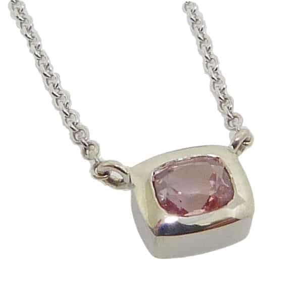 14k white gold bezel set 0.506ct pink sapphire with a 14k white gold 16" adjustable light cable chain.