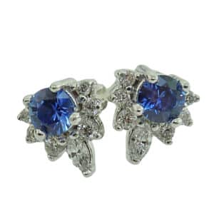 14K white gold stud earrings set with 2 sapphires, 0.359cttw, and 0.166cttw, H/I, SI3/I1, round brilliant cut diamonds.
