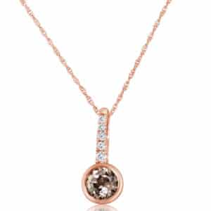 14K rose gold pendant set with a 0.80ct Lotus garnet and accented with 5 = 0.07cttw H/I, SI2, round brilliant cut diamonds. 