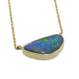 14K yellow gold pendant bezel set with a boulder opal. This pendant comes on a 14K yellow gold chain. Opal is the birthstone for October.