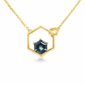 14K yellow gold hexagon pendant set with a hexagon cut 0.57ct Montana Sapphire