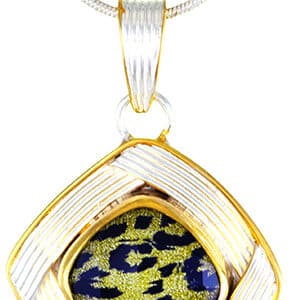 Sterling silver pendant bezel set with Quartz Lazuardi. This pendant is accented with 22 karat yellow gold vermeil and comes with a sterling silver chain.
