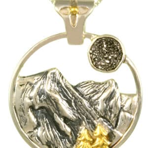 Sterling silver pendant bezel set with Druzy. This pendant is accented with 22 karat yellow gold vermeil and comes with a sterling silver chain.