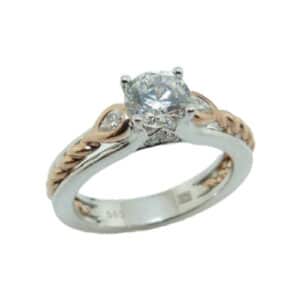 14K White and rose gold diamond engagement ring by Frederic Sage set with a 0.75 carat CZ in the centre and accented on each side with 2 bezel set pear shaped diamonds, 0.10 total carat weight, G/H, VS-SI and on the profile with 6 round brilliant cut diamonds, 0.03 total carat weight, G/H, VS-SI. Available in 14K gold, 18K gold, or platinum. This ring can be made in any combination of white, pink or yellow gold and can be customized to accommodate different size and shape diamonds, by special order. Priced without a center gemstone. Let us find you the perfect center that fits your tastes and budget!