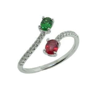 14K White gold lady's bypass ring  set with 0.50ct oval red spinel and 0.50ct oval tsavorite garnet accented with 0.12 total carat weight claw set round brilliant cut diamonds.