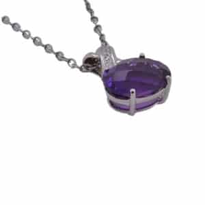 14 karat white gold pendant set with a 2.6 carat oval, checkerboard cut amethyst and five round brilliant cut diamonds totaling 0.02 carats, G/H, VS-SI.