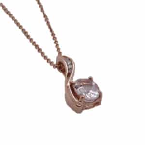 14 karat rose gold pendant set with a 0.70 carat oval morganite and four round brilliant cut diamonds totaling 0.05 carats, G/H, VS-SI.