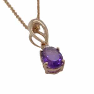 14K Yellow gold pendant set with a 0.80ct oval amethyst & 0.02ct round brilliant cut diamond.