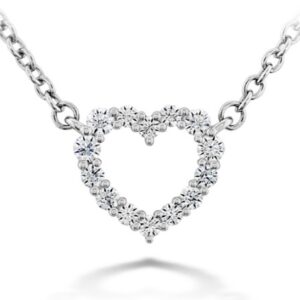 18K White gold Signature Heart Pendant by Hearts On Fire on 18" chain set with 0.13 total carat weight ideal, round brilliant cut Hearts On Fire diamonds, G/H, VS-SI.