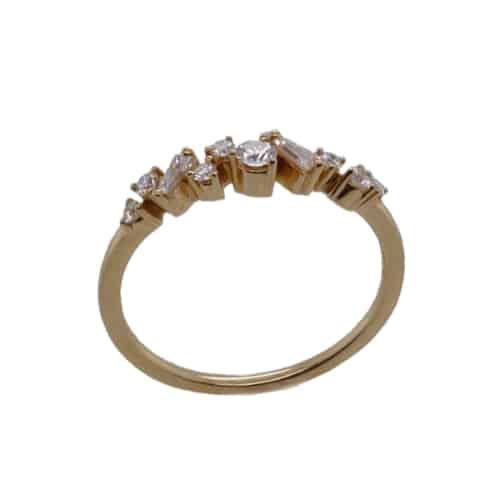 18k yellow gold band set with two tapered baguette diamonds and five round brilliant cut diamonds totaling 0.25cttw