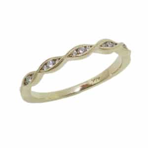Lady's 14K yellow gold diamond twist band with milgrain detail pave set with 15 round brilliant cut diamonds, totaling 0.08 carats.