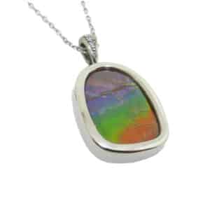 14K White gold custom pendant by Studio Tzela bezel set with a 11.75 carat natural ammolite and accented on the bale with three round brilliant cut diamonds, 0.015 total carat weight, H, SI1-2.