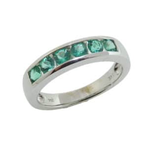 14K White gold lady's band channel set with six round emeralds, 0.54 total carat weight.