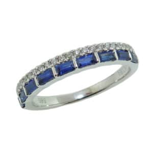 14K white gold illusion stacked ring set with nine blue sapphire baguettes, totaling 0.55 carats, and accented with 25 round brilliant cut diamonds totaling 0.13 carats.