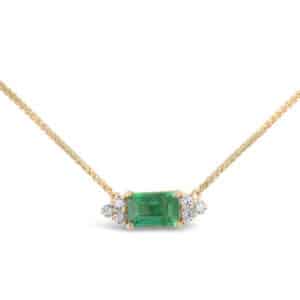 14K Yellow gold pendant on an 18" wheat chain set with a 0.52 carat emerald cut emerald and accented with six round brilliant cut diamonds, 0.078 total carat weight, H/I, SI2.