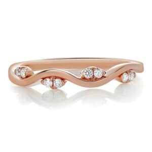 14K Rose gold lady's band set with 8 round brilliant cut diamonds, 0.09 total carat weight.
