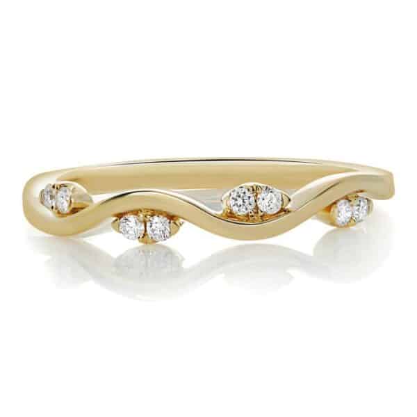 14K Yellow gold ladies diamond band, set with 8 round brilliant cut diamonds totaling 0.09 carats. Size 6.50