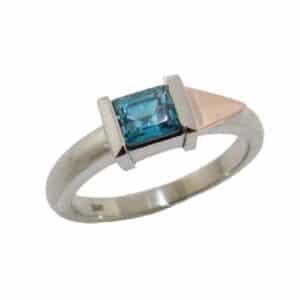 14K Rose and white gold lady's coloured gemstone ring set with a 0.833 carat emerald cut blue zircon.