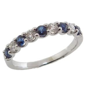 14K White gold lady's band claw set with alternating 4 round brilliant cut diamonds, 0.23 total carat weight, and 5 blue sapphires, 0.34 total carat weight.