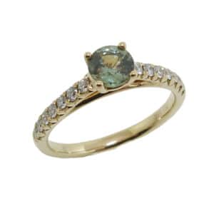 14K Yellow lady's coloured gemstone ring set with 0.62 carat green sapphire and accented with 0.25 total carat weight round brilliant cut diamonds.