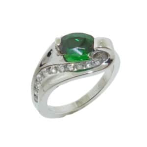14K White gold lady's ring claw set with an oval tsavorite garnet, 1.40 carat, and 11 channel set round brilliant cut diamonds, 0.20cttw.