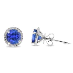 14K White gold halo studs set with 2 round tanzanites, 2.50 total carat weight, and accented in each halo with 48 round brilliant cut diamonds, 0.16 total carat weight.