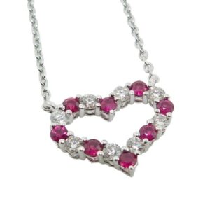 14K White gold heart pendant on a 18" adjustable chain set in an alternating pattern with 8 rubies, 0.20 total carat weight, and 8 round brilliant cut diamonds, 0.16 total carat weight.