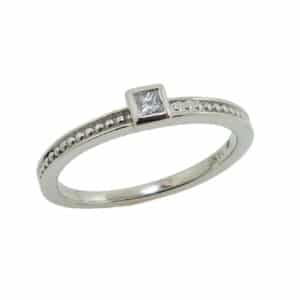14K white gold engagement ring bezel set with a 0.05 carat G-H, SI1 princess cut diamond.