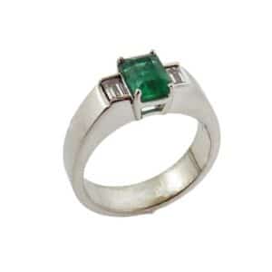 Lady's 14 Karat white gold custom coloured gemstone ring set with one 0.98 carat emerald cut emerald in the center and accented by two emerald cut diamonds totaling 0.306 carats, VS, G/H.