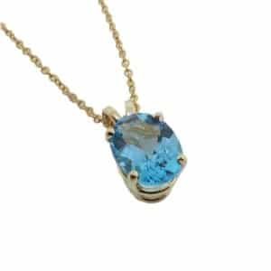 14K Yellow gold pendant set with a 2.07 carat oval blue topaz.