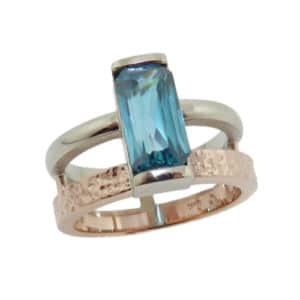 14K polished white gold and hammered rose gold custom lady's ring by Studio Tzela set with a 3.77 carat blue zircon.